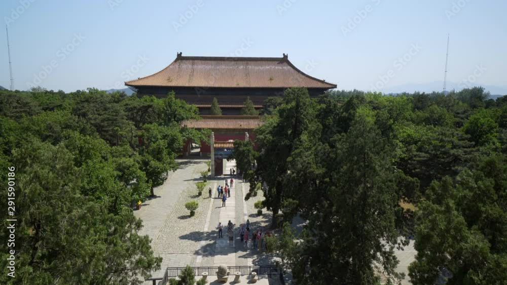 Tourists exploring Lingxing Gate amidst trees on sunny day - Beijing, China