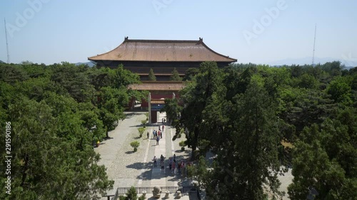 Tourists exploring Lingxing Gate amidst trees on sunny day - Beijing, China photo