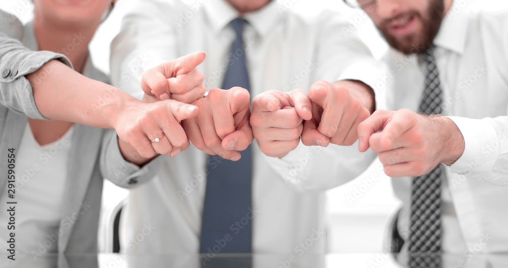 close up.a smiling business team pointing at you close up.a smiling business team pointing at you