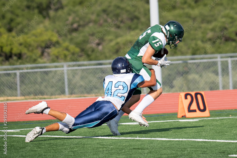 Fototapeta premium Great action photos of high school football players making amazing plays during a football game
