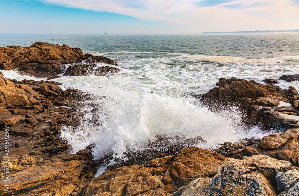 Beautiful landscape with waves crushing on the rocks on the Brittany coastline in North of France.