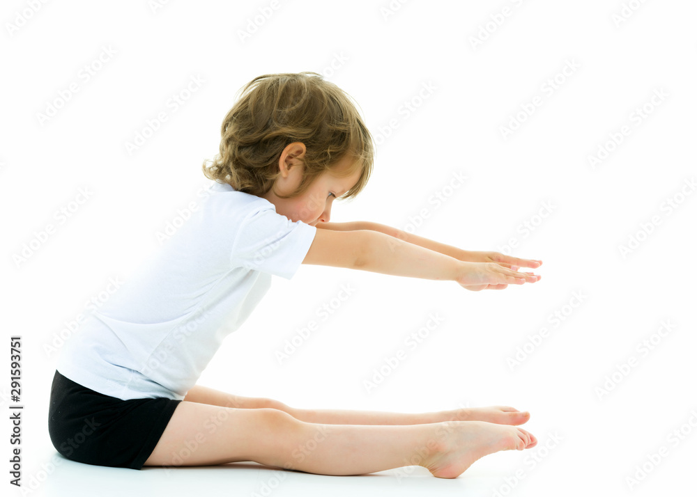 Charming little girl doing gymnastic exercises in the studio on Charming little girl doing gymnastic exercises in the studio on