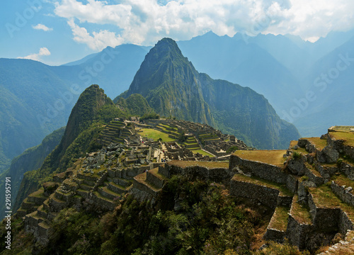 Machu Picchu, Cusco region, Peru: Overview of agriculture terraces, Wayna Picchu and surrounding mountains in the background, UNESCO, World Heritage Site. One of the New Seven Wonders of the World