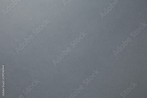 A sheet of dark gray paper. Blank background sample of dense saturated color for photography and design ideas