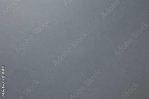 A sheet of dark gray paper. Blank background sample of dense saturated color for photography and design ideas © udovichenko