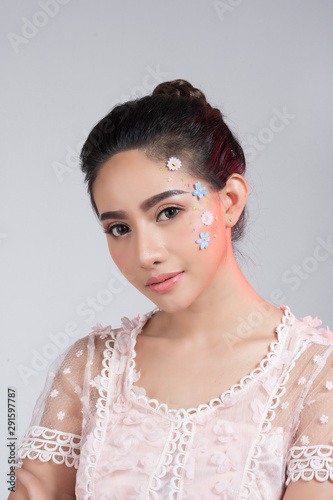 Fashion beauty makeup with flowers on face beautiful woman.