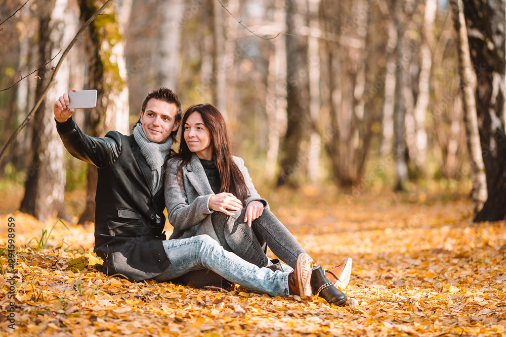 Happy family walking in autumn park on sunny fall day Happy family walking in autumn park on sunny fall day