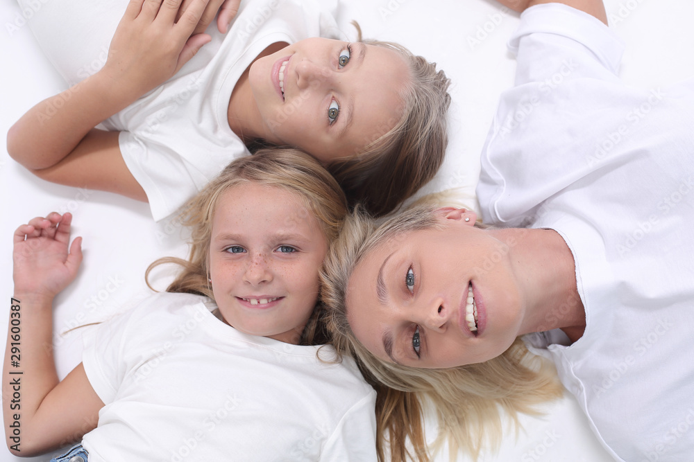 happy mother and daughters lying down together