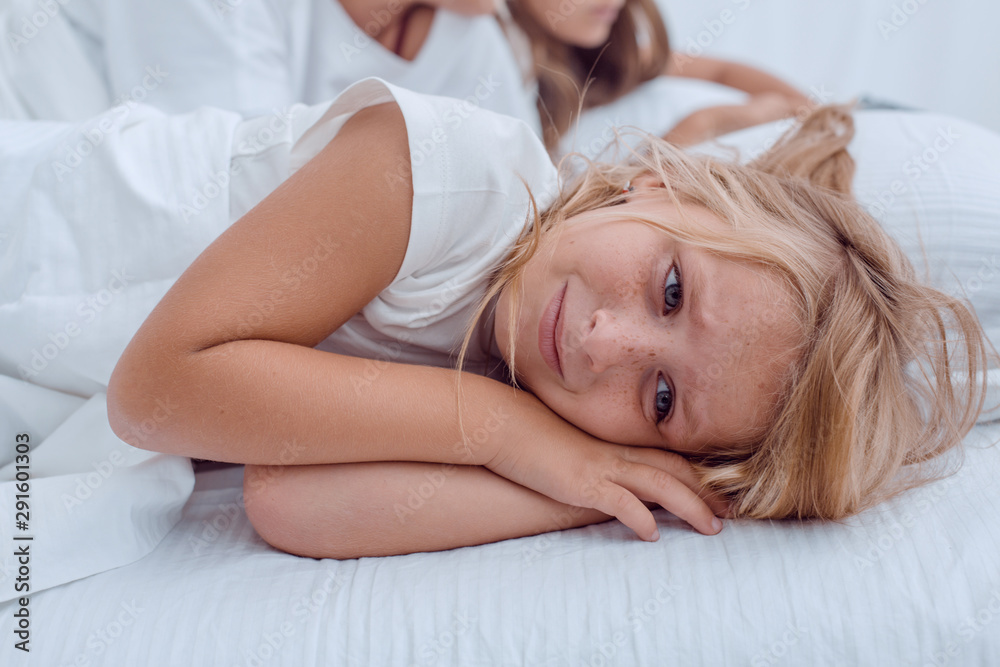 pretty little girl lying on her parents bed pretty little girl lying on her parents bed