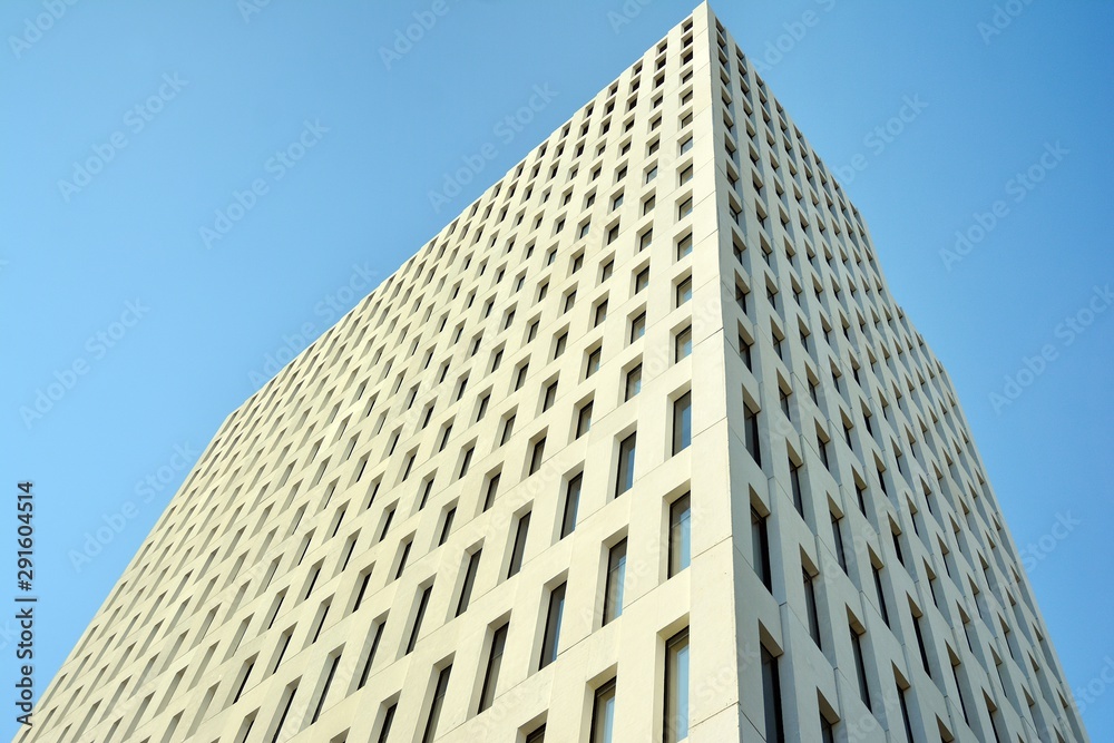 Modern office building detail. Perspective view of geometric angular concrete windows on the facade of a modernist brutalist style building. Modern office building detail. Perspective view of geometric angular concrete windows on the facade of a modernist brutalist style building.