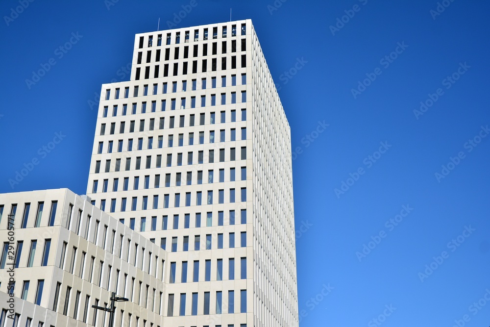 Modern office building detail. Perspective view of geometric angular concrete windows on the facade of a modernist brutalist style building. 