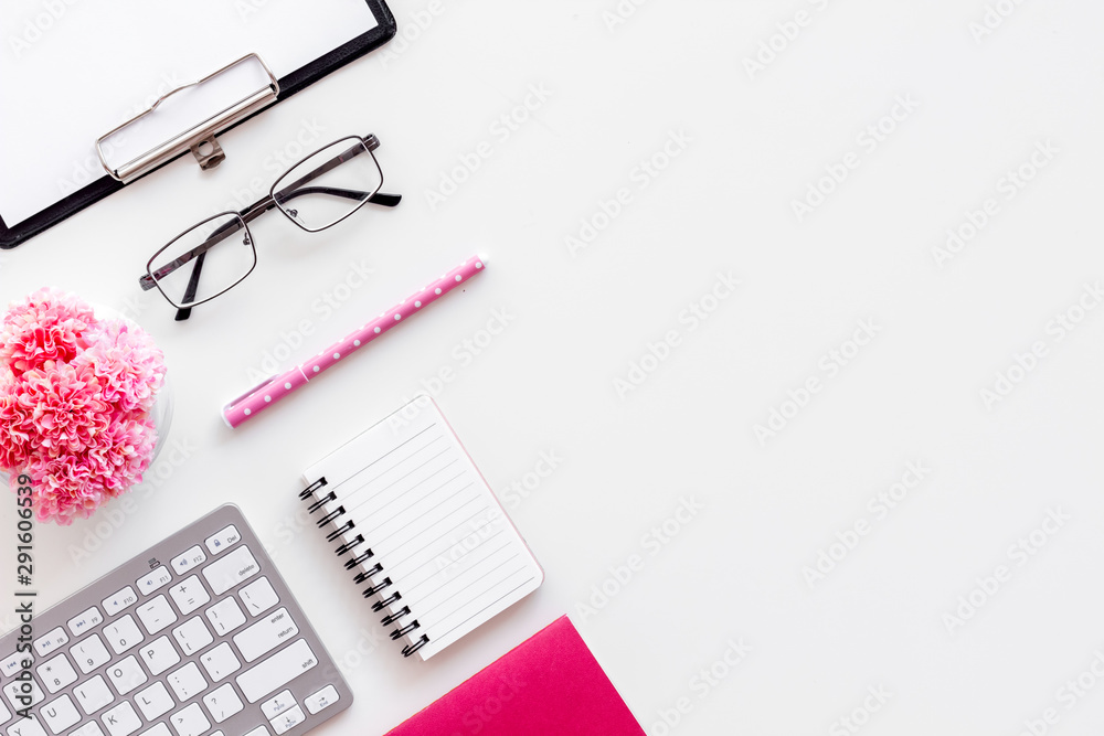 Female work desk with pink supplies on white background flat lay copy space top view Female work desk with pink supplies on white background flat lay copy space top view