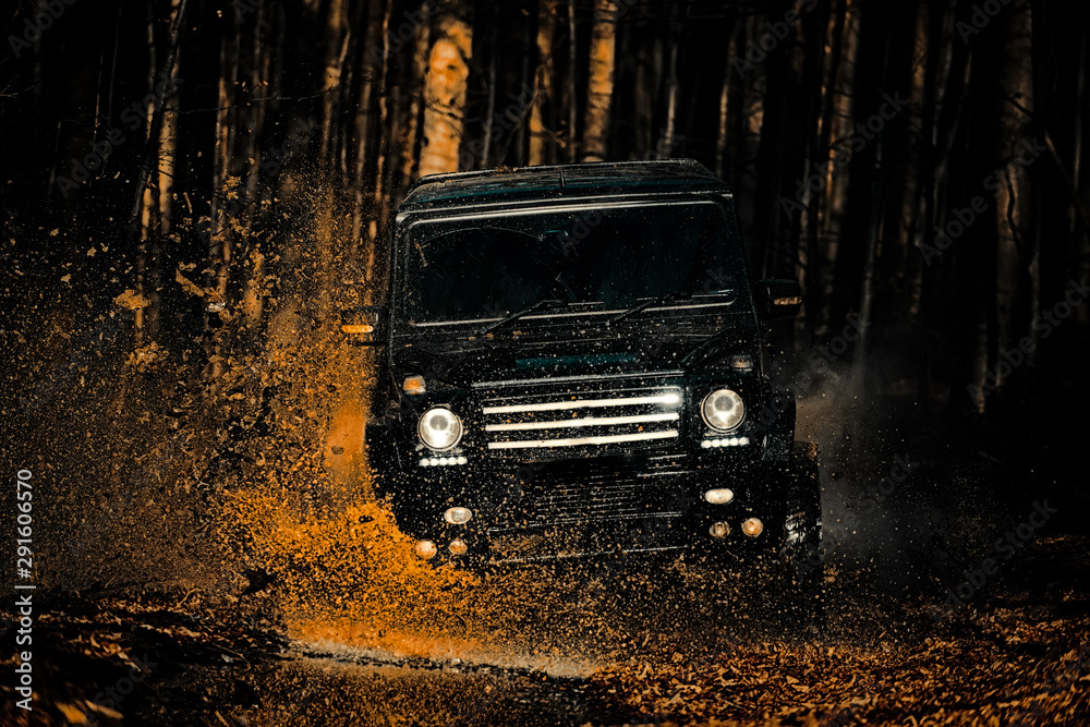 Mud and water splash in off the road racing. Motion the wheels tires ...