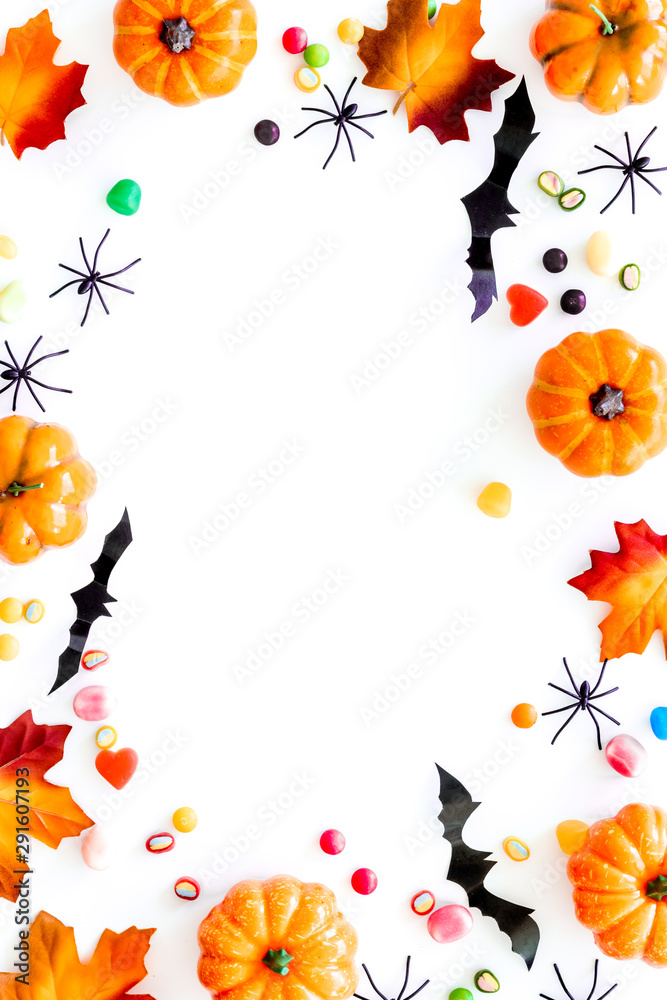 Halloween composition with sweets on white background top view frame space for text