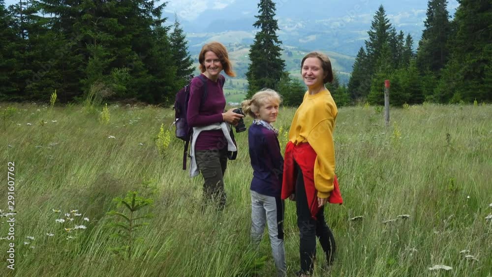 mother with daughters hiking in the mountains at the summer mother with daughters hiking in the mountains at the summer