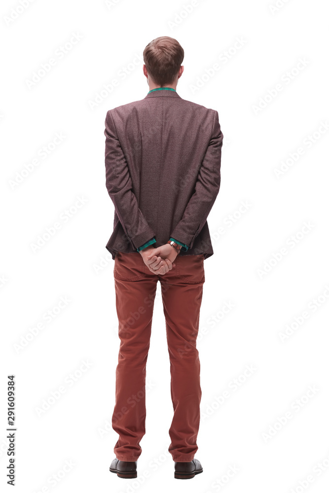 rear view. young man standing in front of white blank screen rear view. young man standing in front of white blank screen