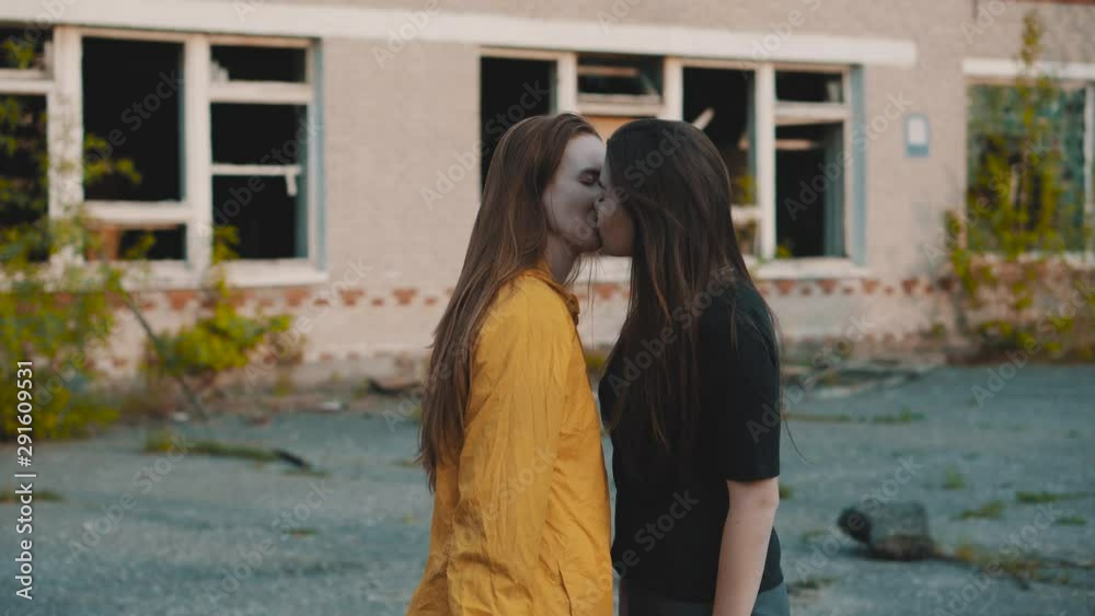 Video Stock Two girls kiss on an abandoned territory. The lesbian was  wearing protective masks. LGBT kiss. Protective suits from radiation. Lesbians  kissing, gender equality. | Adobe Stock