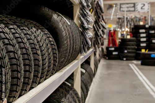 Car tires and wheels at warehouse in tire store. © volody10