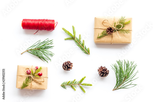 Winter festive layout with spruce branches and New Year presents on white background top view flat lay