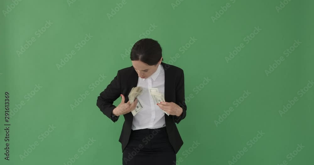 Careful businesswoman hiding cash dollars under her clothes Careful businesswoman hiding cash dollars under her clothes