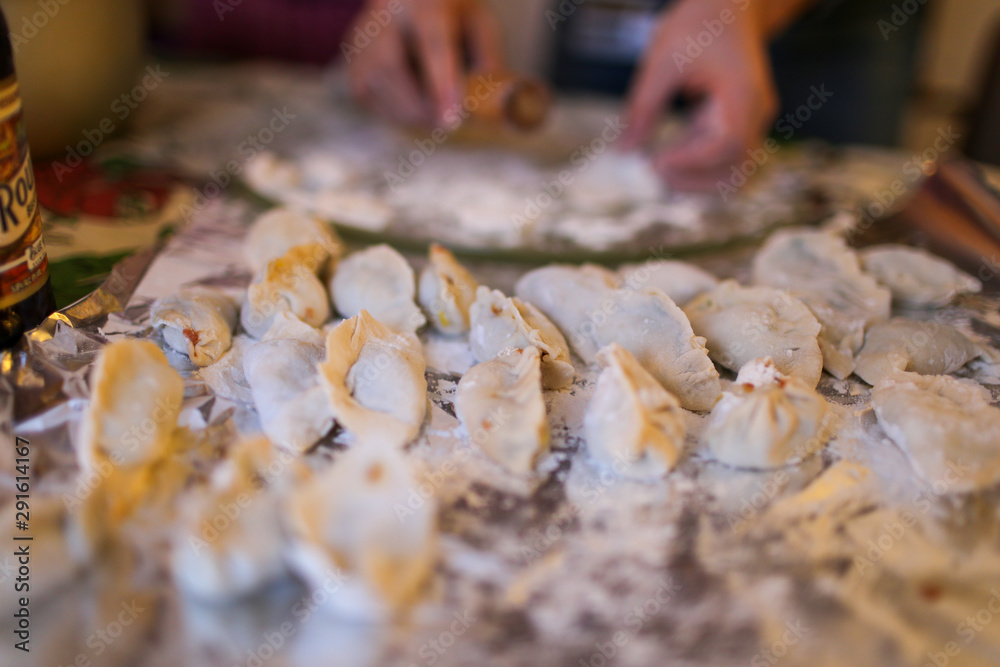 Mom making dumpling for transitional Chineses New year Mom making dumpling for transitional Chineses New year