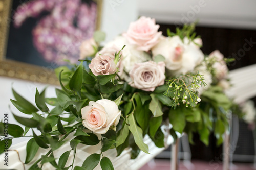 The staircase is decorated with fresh flowers and a plate Wedding. Wedding floristry. The decor of the room at the wedding