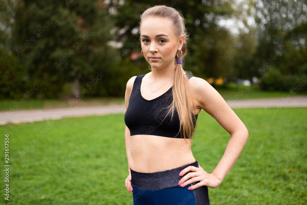 Beautiful athletic girl in topic posing on the sports field. Beautiful athletic girl in topic posing on the sports field.