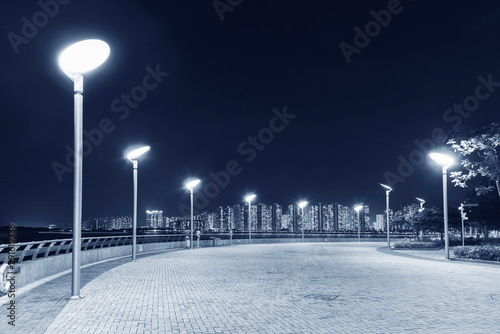 Seaside Promenade of Harbor in Hong Kong city at night photo