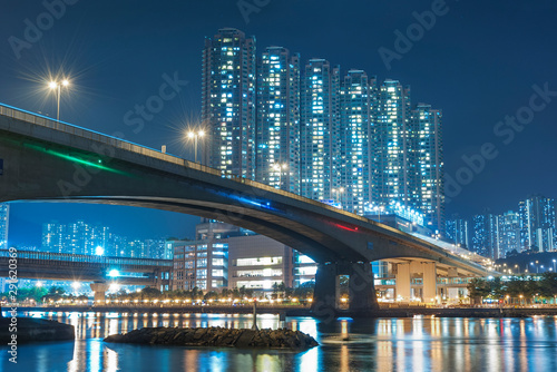 high rise residential building and bridge in Hong Kong city at night