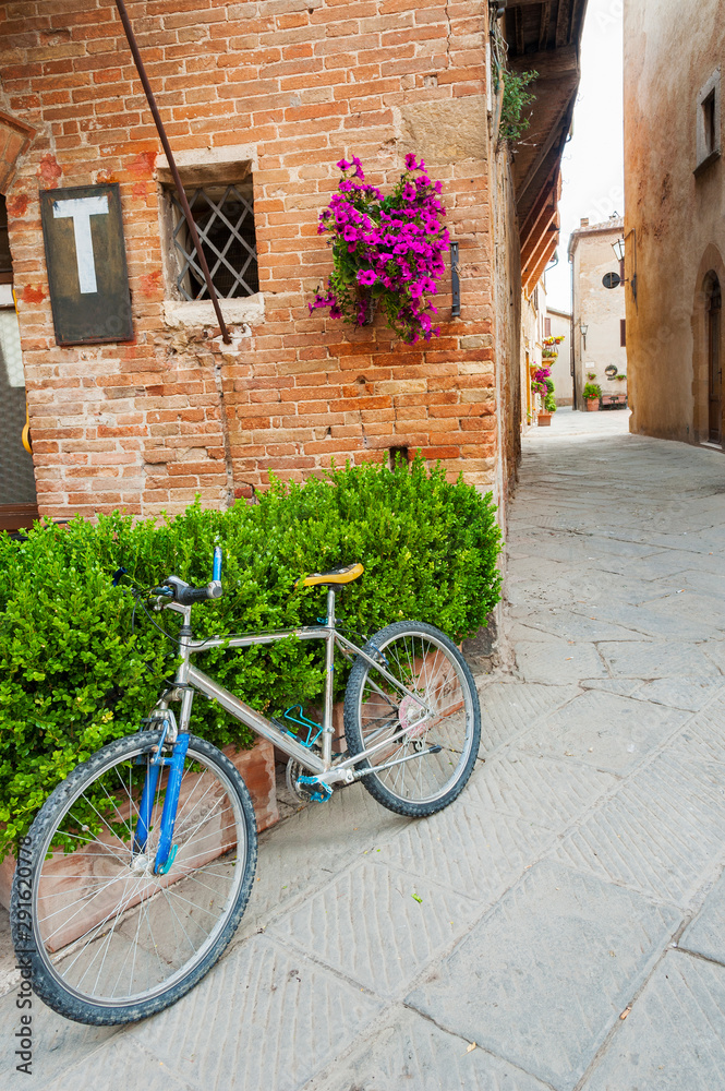 Bicycle in charming street in old town Pienza of Tuscany, Italy, Europe Bicycle in charming street in old town Pienza of Tuscany, Italy, Europe