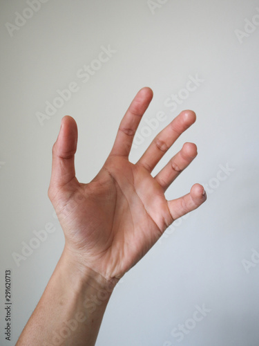 a hand holding something on white background.