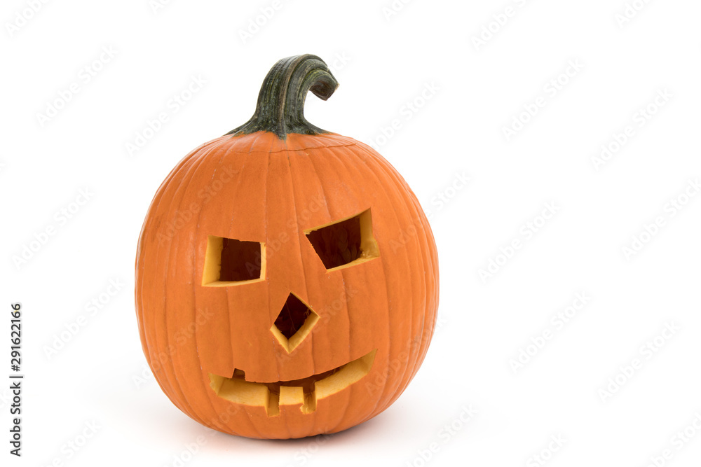 Carving a large pumpkin into a Halloween jack o'lantern isolated on white background