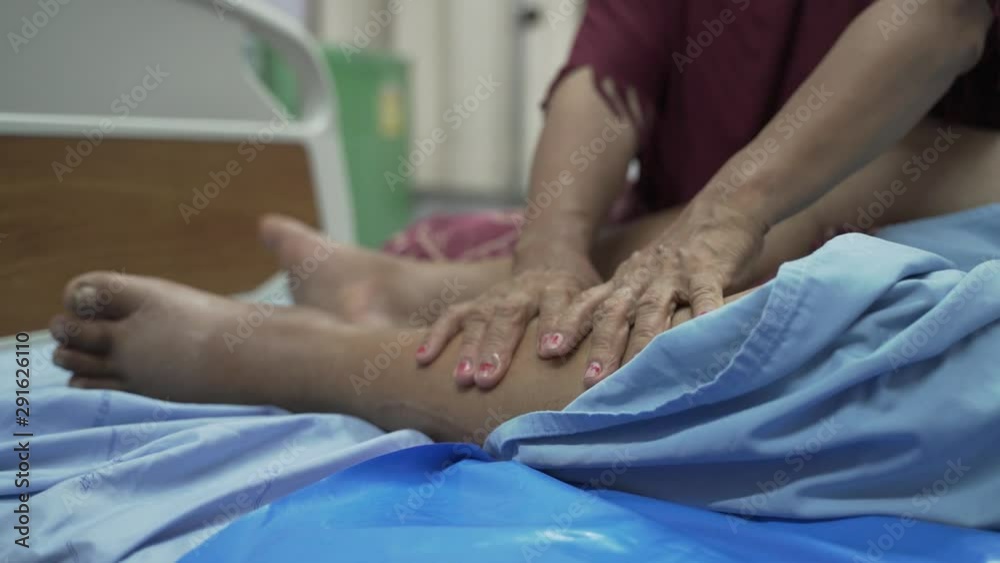 Hands massaging swollen leg, ankle and feet for Edema patient