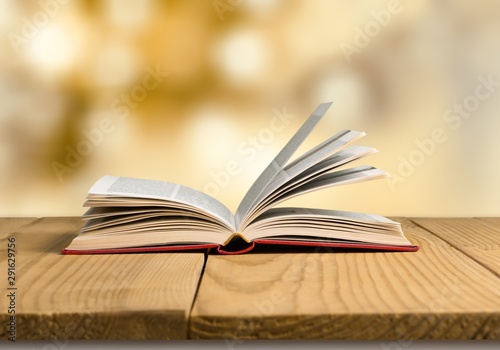 Open book on old wooden table. © BillionPhotos.com