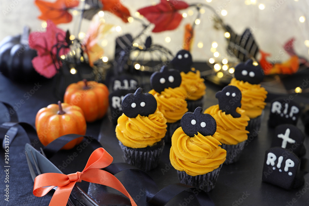 Halloween cupcakes decorated with pumpkin fresh cream 