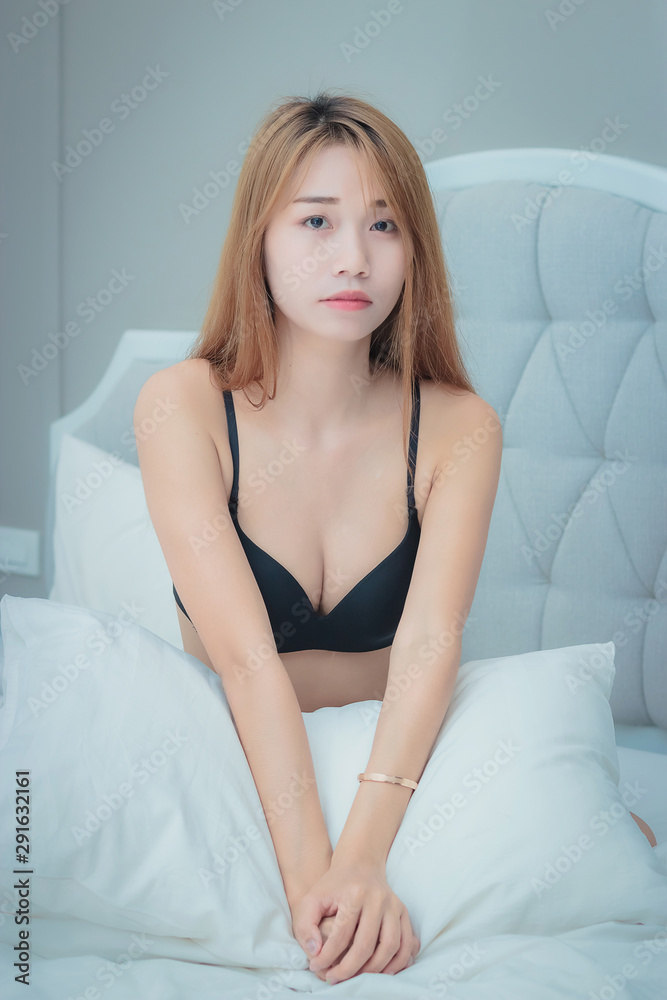 Sexy asian woman in lingerie, sitting relax on her bed Sexy asian woman in lingerie, sitting relax on her bed