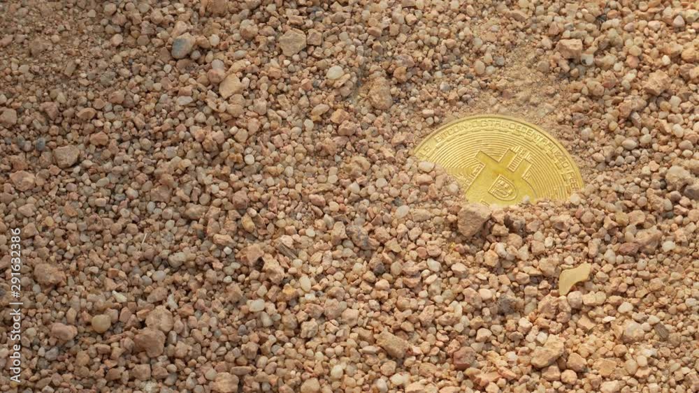 Bitcoin on the sand by the sea at the summer day Bitcoin on the sand by the sea at the summer day
