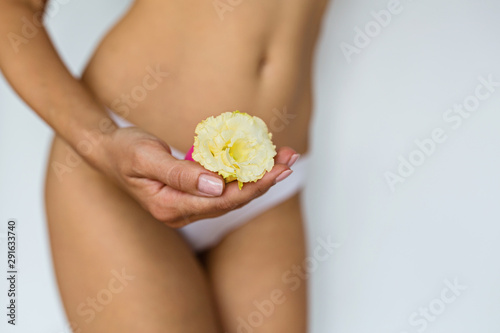 woman holding menstrual cup on front of her private parts. Feminine hygiene alternative product instead of tampon during period. Menstruation, critical days, women periods. Zero waste, eco, ecology. photo