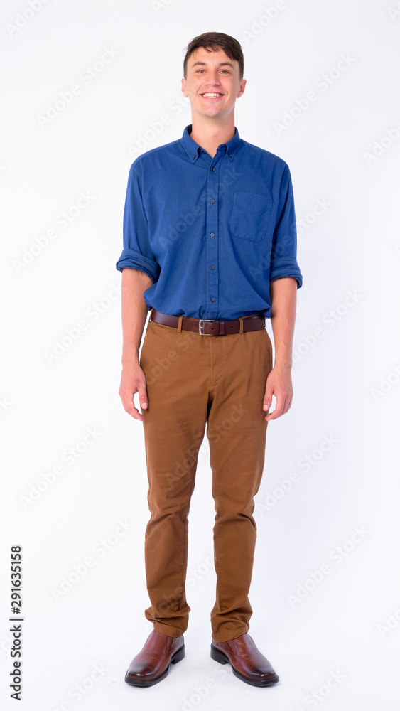 Full body shot of happy young handsome businessman smiling