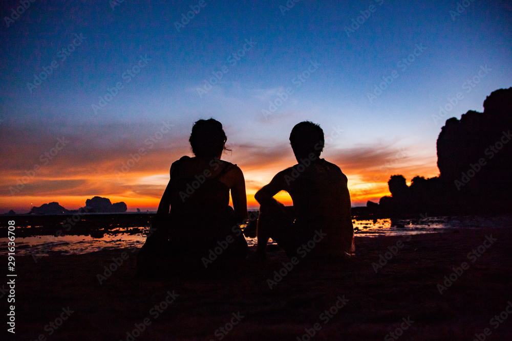 couple silhouette watching amazing sunset on the beach in Krabi  Thailand