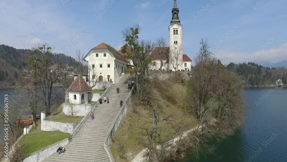 Flying over the island with small church located in the middle of the Lake Bled, Slovenia Flying over the island with small church located in the middle of the Lake Bled, Slovenia