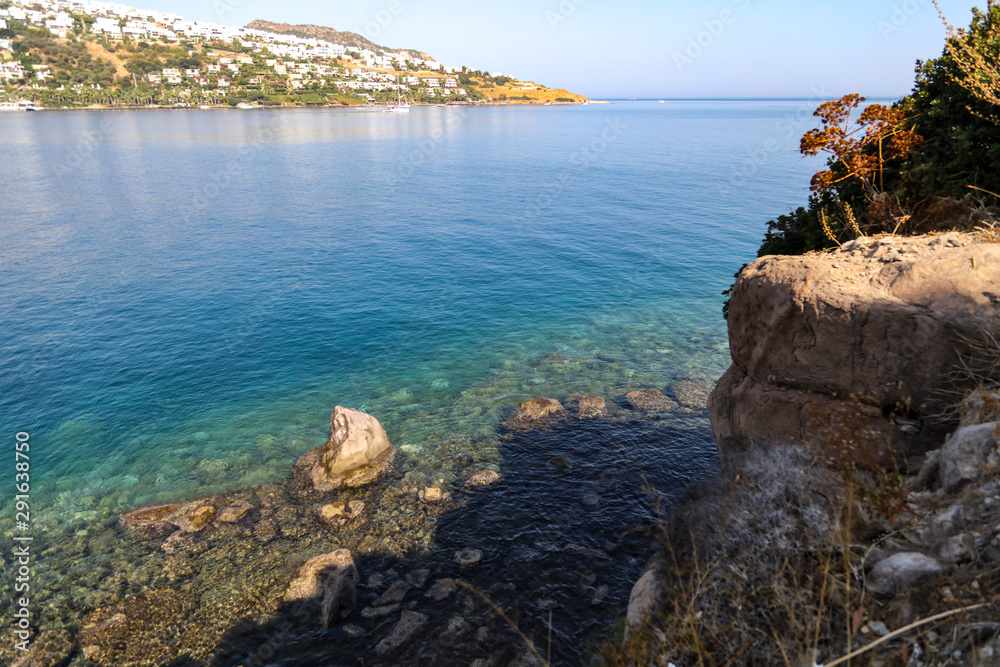 Blue water and rocky coast of the Aegean Sea as a background