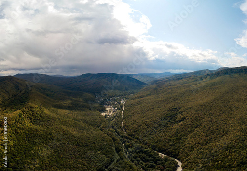 aerial view of the village of Planicheskaya slit in a mountain gorge (Western Caucasus, South of Russia) on a rainy cloudy day in early autumn