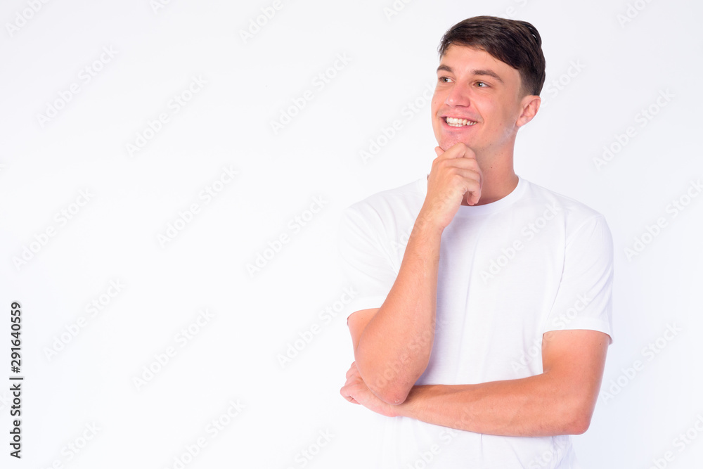 Portrait of happy young handsome man thinking and looking up Portrait of happy young handsome man thinking and looking up