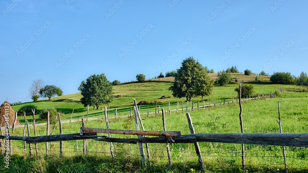 Typical Countryside Landscape Of Romania With Wooden Fence