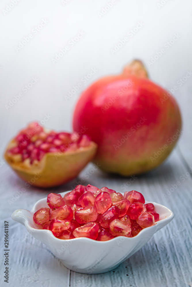 Pomegranate fresh fruit on wood white background. Pomegranate fresh fruit on wood white background.
