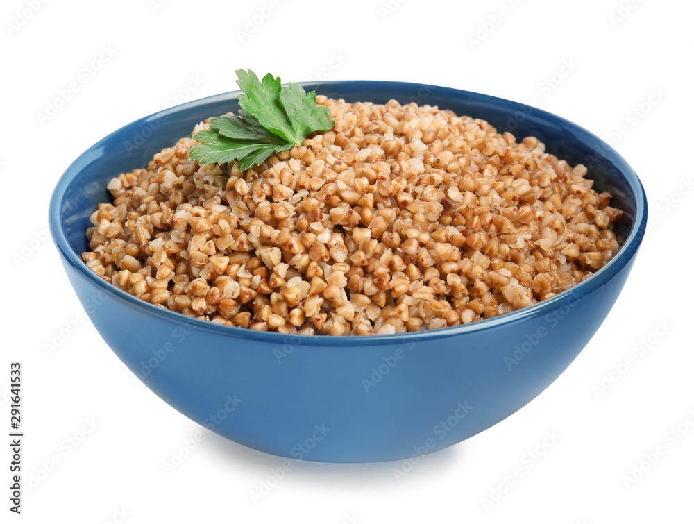 Bowl of buckwheat porridge with parsley isolated on white