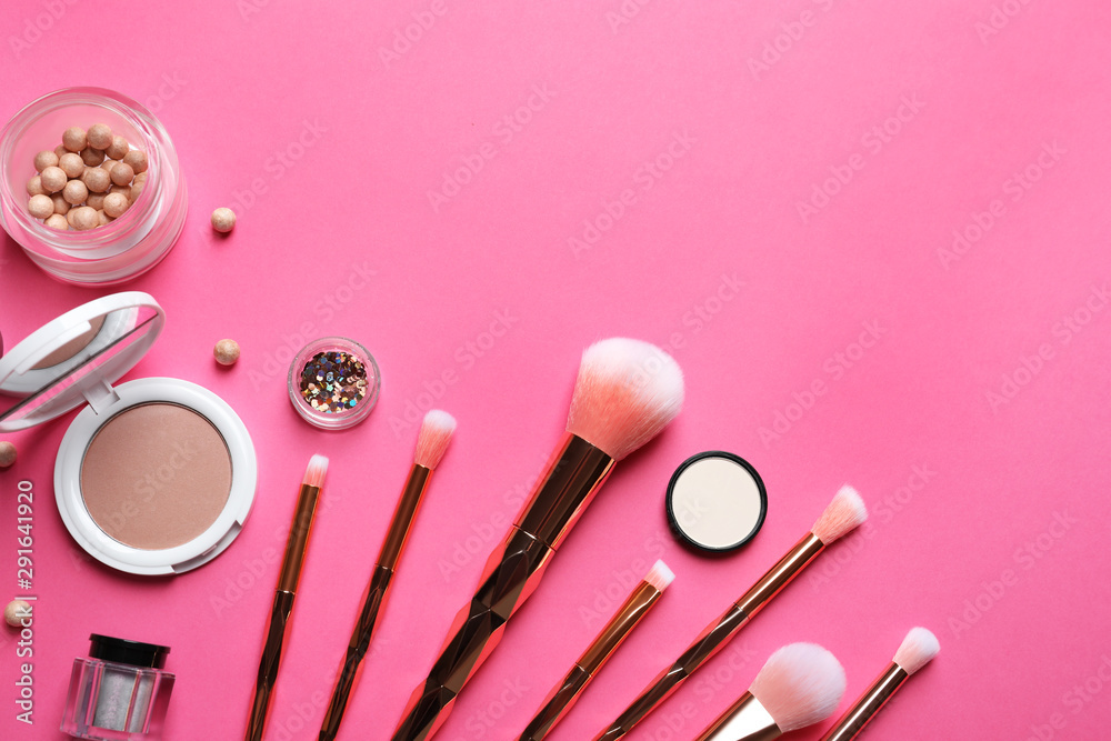 Fototapeta Flat lay composition with makeup brushes on pink background. Space for text