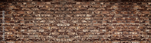 Wide red shabby brick wall texture. Old masonry large backdrop. Peeled orange...