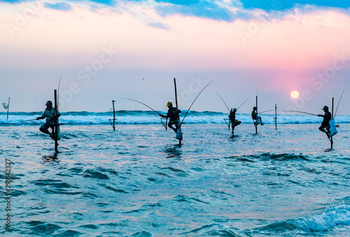 stilt fishermen at sunset in Sri Lanka